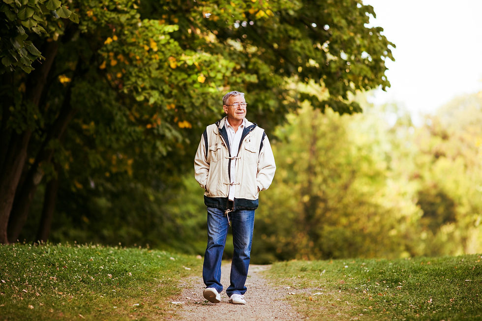 Older man walking outside on a trail