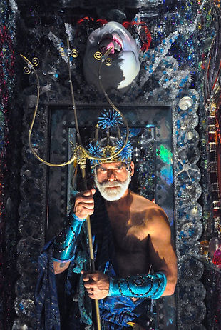 A man wearing a Poseidon costume and holding a trident
