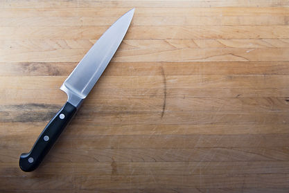 A%20large%20knife%20sits%20on%20a%20worn
