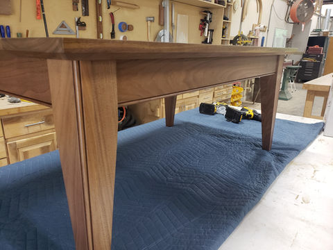 Custom walnut coffee table with bead detail on legs and apron