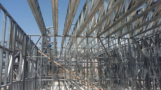 Metal framework of a building under construction, clear sky.