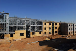 Metal framework of a building under construction, clear sky.