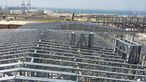 Metal framework of a building under construction, clear sky.