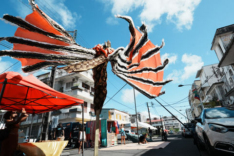 Trinidad & Tobago stilts artists walking through the streets of the Assainissement neighbourhood, Pointe-à-Pitre (Guadeloupe).
