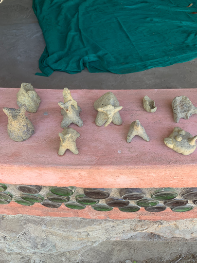 Paper mache sculptures created by children that depict various animals such as elephant, dog, peacock , etc.