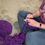Thumbnail: Person hand-crocheting with purple yarn