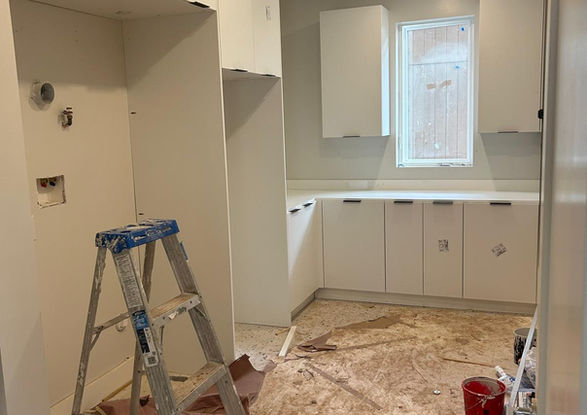 White laundry room with counters and cabinets. Valley Custom Closets