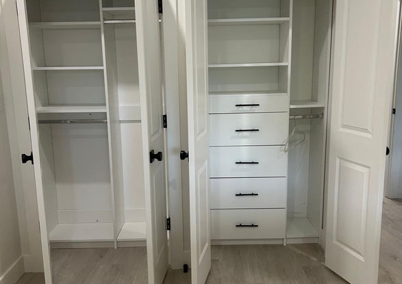 Open white closet with shelves and drawers. Valley Custom Closets interior design.