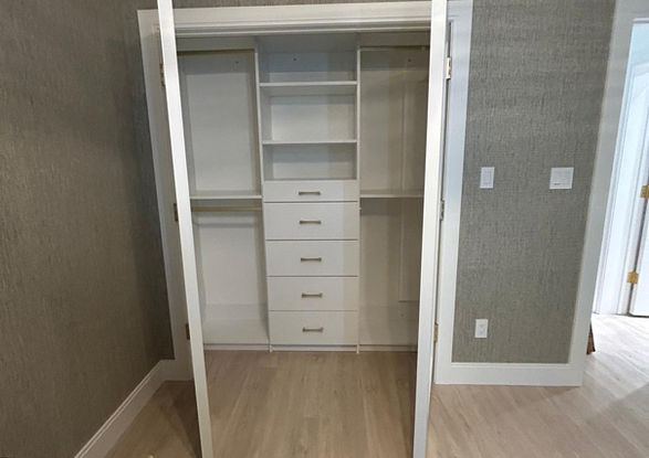 White Reach In closet with drawers and shelves, wood floor, Valley Custom Closets.