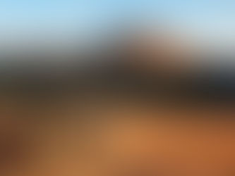 A jeep safari drives through a rugged Indian national park landscape with rocky hills in the background, capturing the essence of wildlife exploration in India.