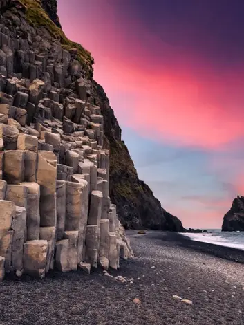 Basalt column cliffs and black sand beach at Reynisfjara on Iceland’s South Coast.