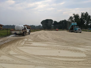 Building a surface that rides right starts long before the first horse steps into the arena. Here, Dan’s team blends and waters new footing to ensure even distribution, proper compaction, and long-term performance.