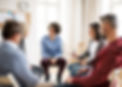 Adults sitting in chairs for a group clinical session