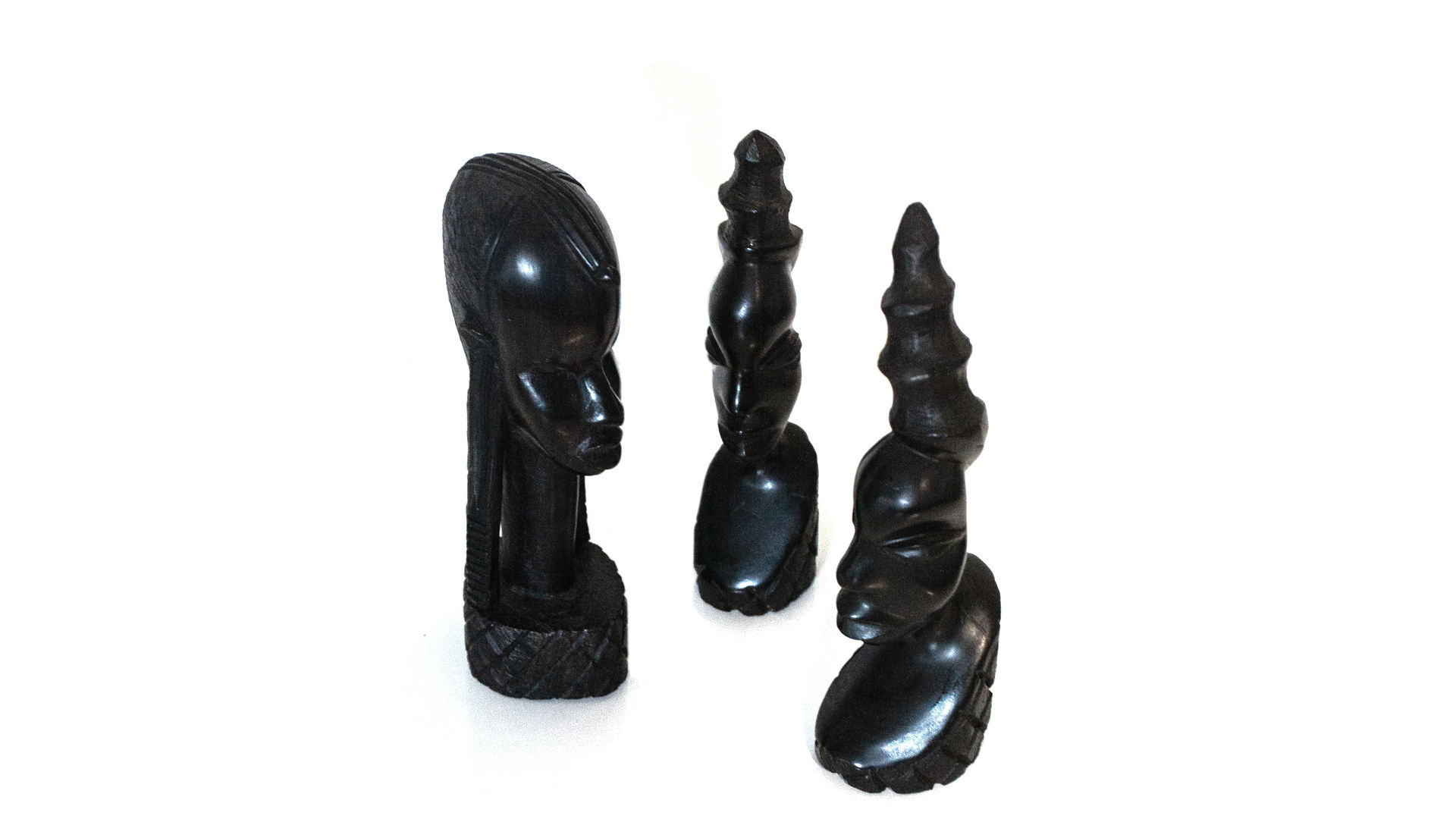 Ebony trio carved figure heads