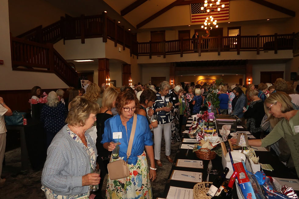 Guests perusing silent auction baskets