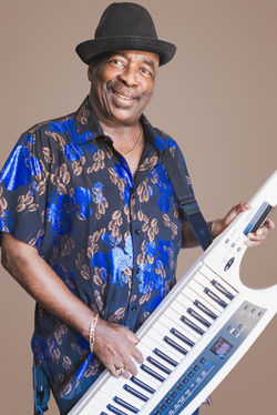 Man with Electric guitar on mocha backdrop