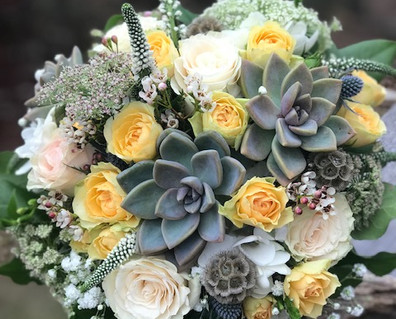 bridal bouquet of yellow spray roses with succulents, baby's breath, veronica and scabiosa pods