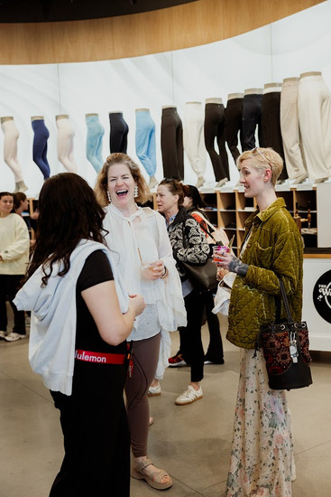 Guests networking during a sip-and-shop experience at lululemon Boston following the Unbuttoned wellness retreat