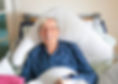 End of life client, smiling from is bed
