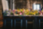 Long tables filled with colorful flowers and candles