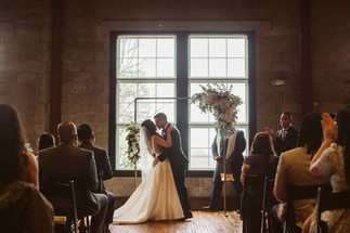 April Wedding in New England altar bride and groom kissing