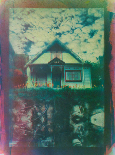 Print of a colorful house with machine parts below the surface