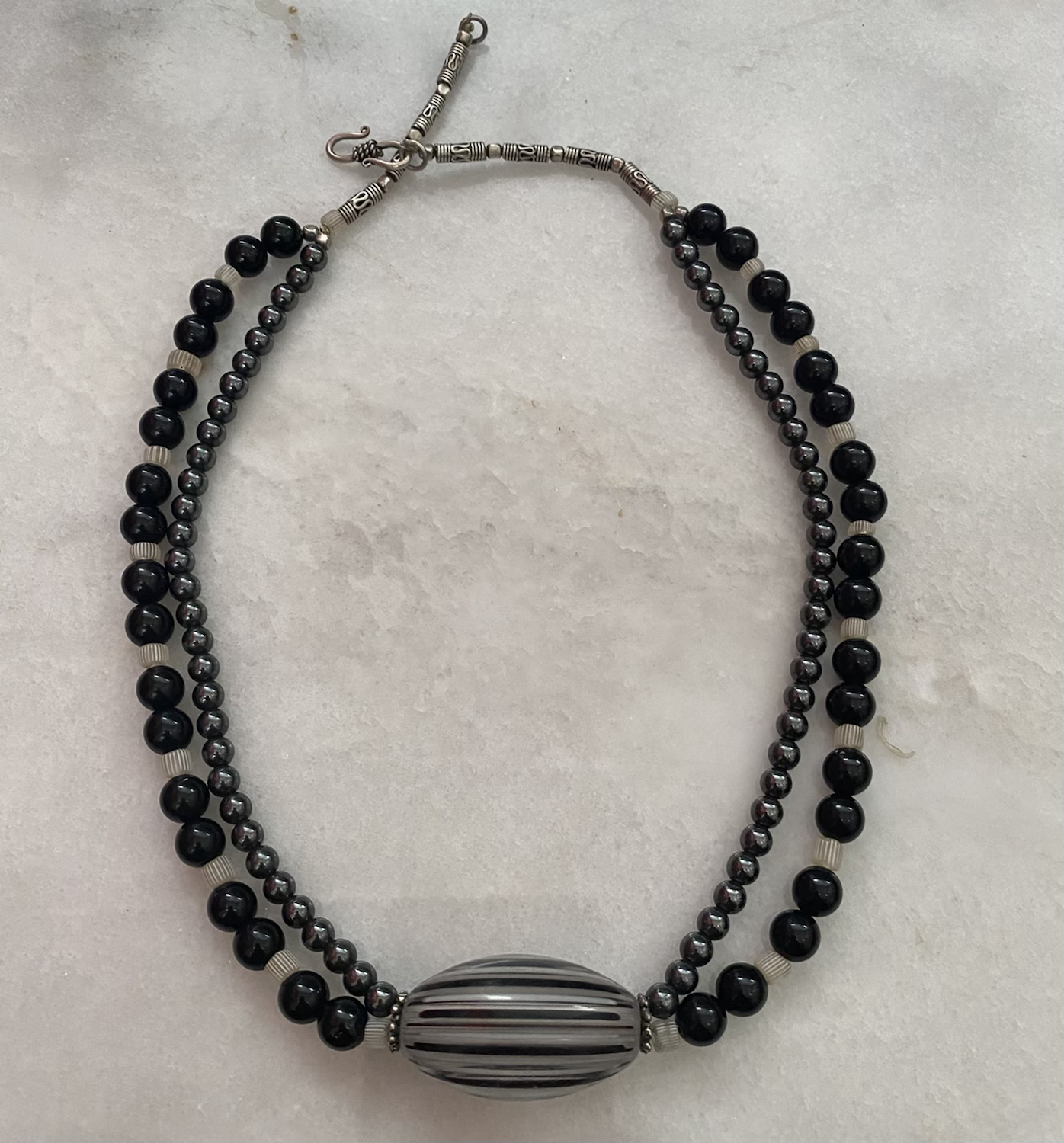 Double strand Hematite and Black Onyx with black and grey striped bead