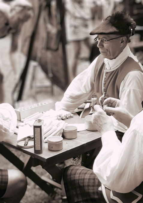 Three men in traditional attire seated at a table