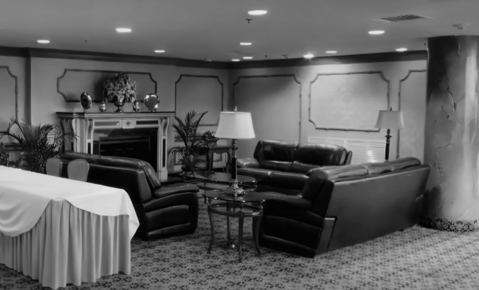 Formal living room with leather sofas, table lamp, fireplace. Architecture with a portfolio.
