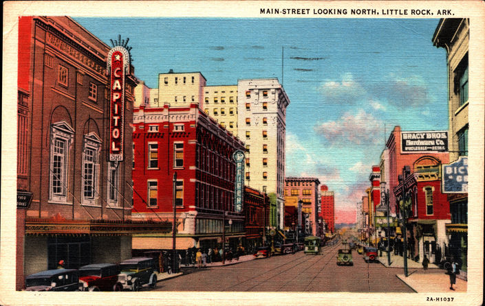 A vintage postcard depicting a town's main street lined with buildings