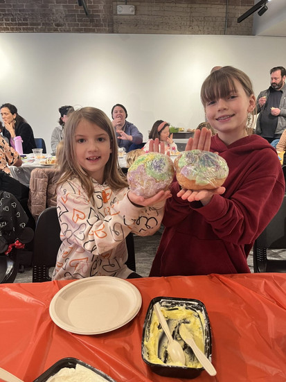 Kids showcase their completed king cake challahs at the January 25th workshop