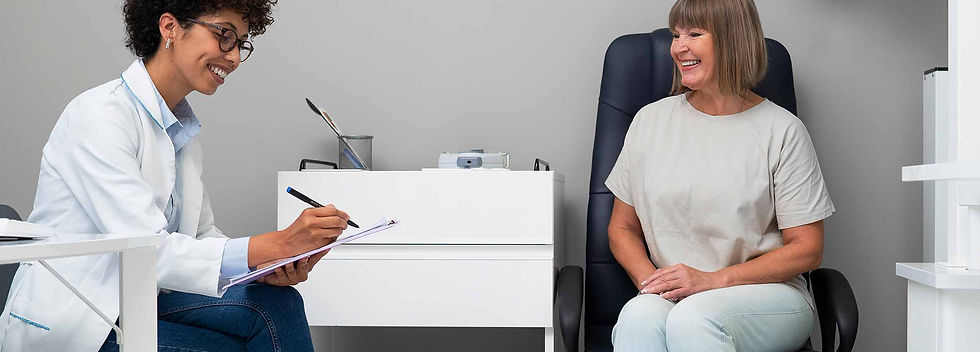 A female ophthalmologist or optometrist in a lab coat smiling while taking notes during a vision consultation with a senior patient for menopause