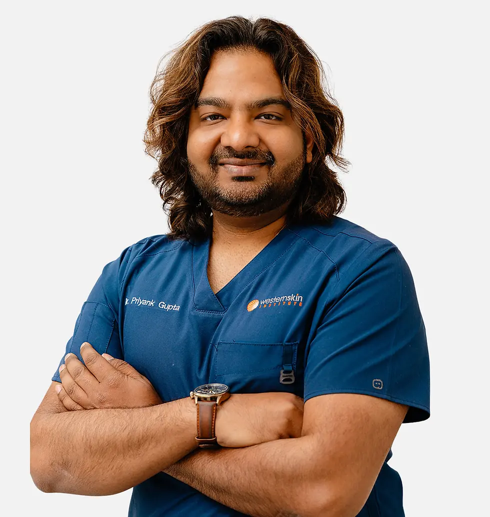 Dr Priyank Gupta in blue medical scrubs with arms crossed