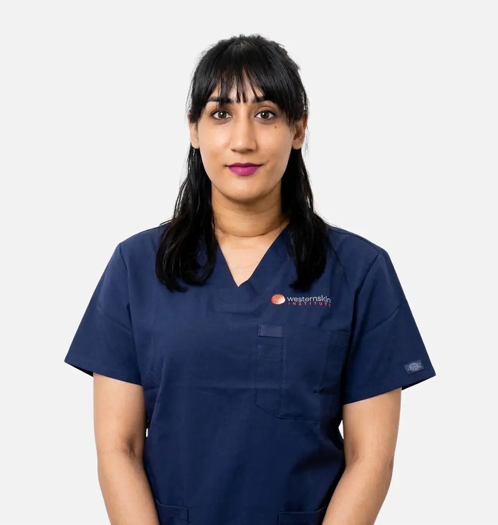 Dr. Navneet (Niv) Sandhu in navy blue medical scrubs.