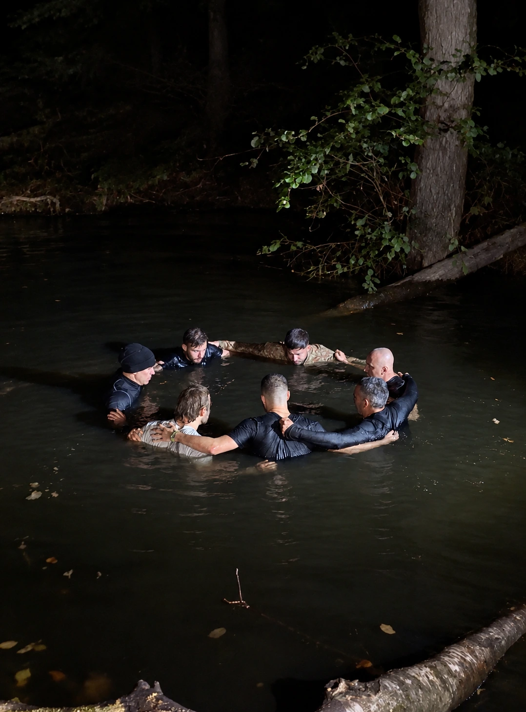 A group linked together during supervised water training at night
