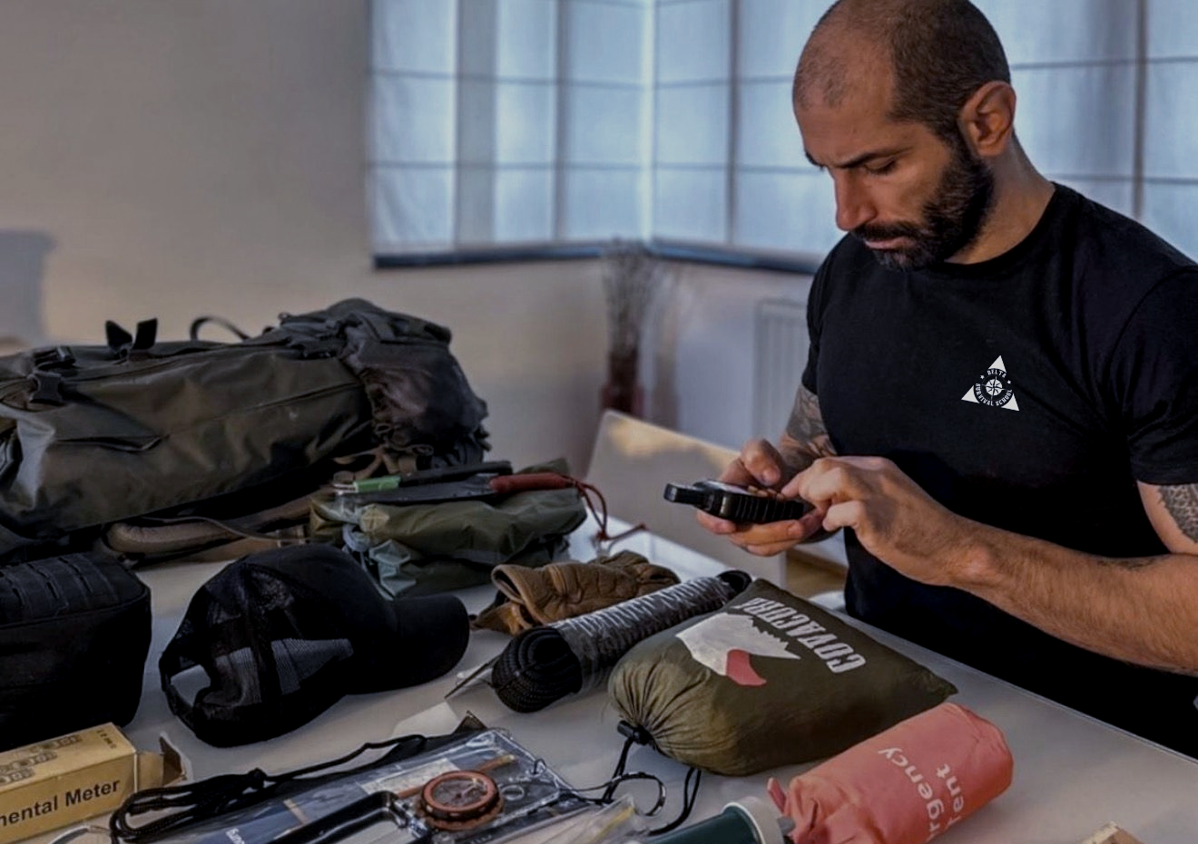 Instructor DELTA reviewing a backpack and preparedness equipment