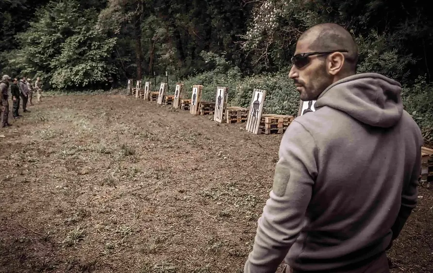 Zurab Tskitishvili, Instructor Delta, supervising a firearms training session at the shooting range for Delta Survival School