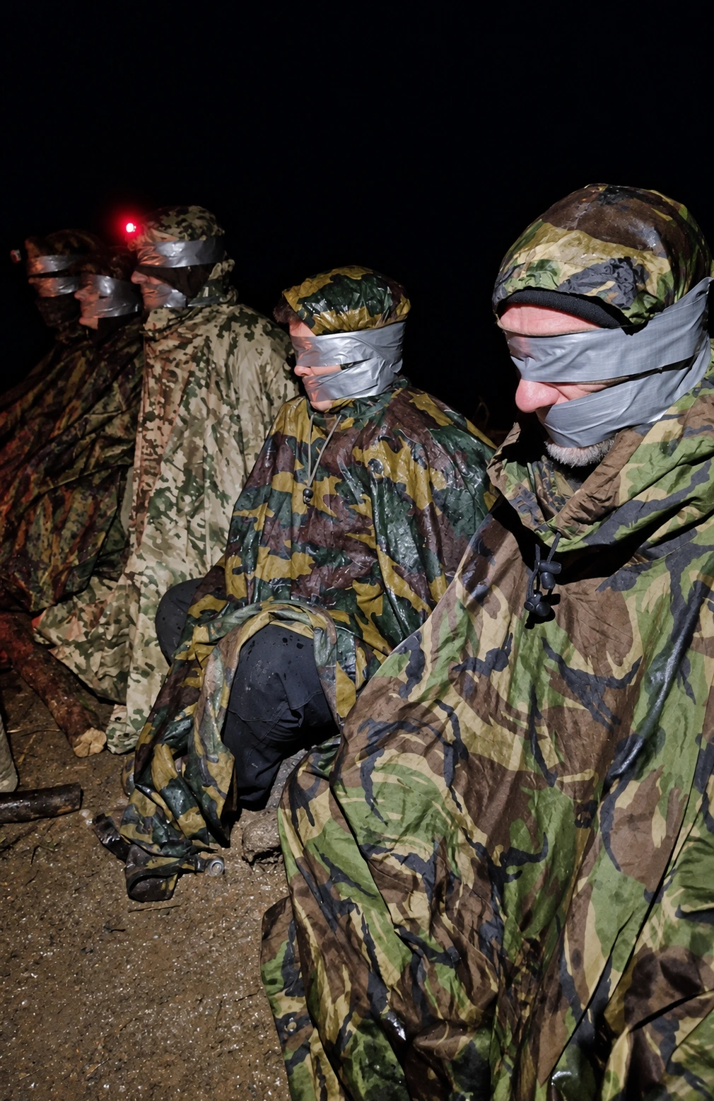 Blindfolded participants during a supervised night training scenario