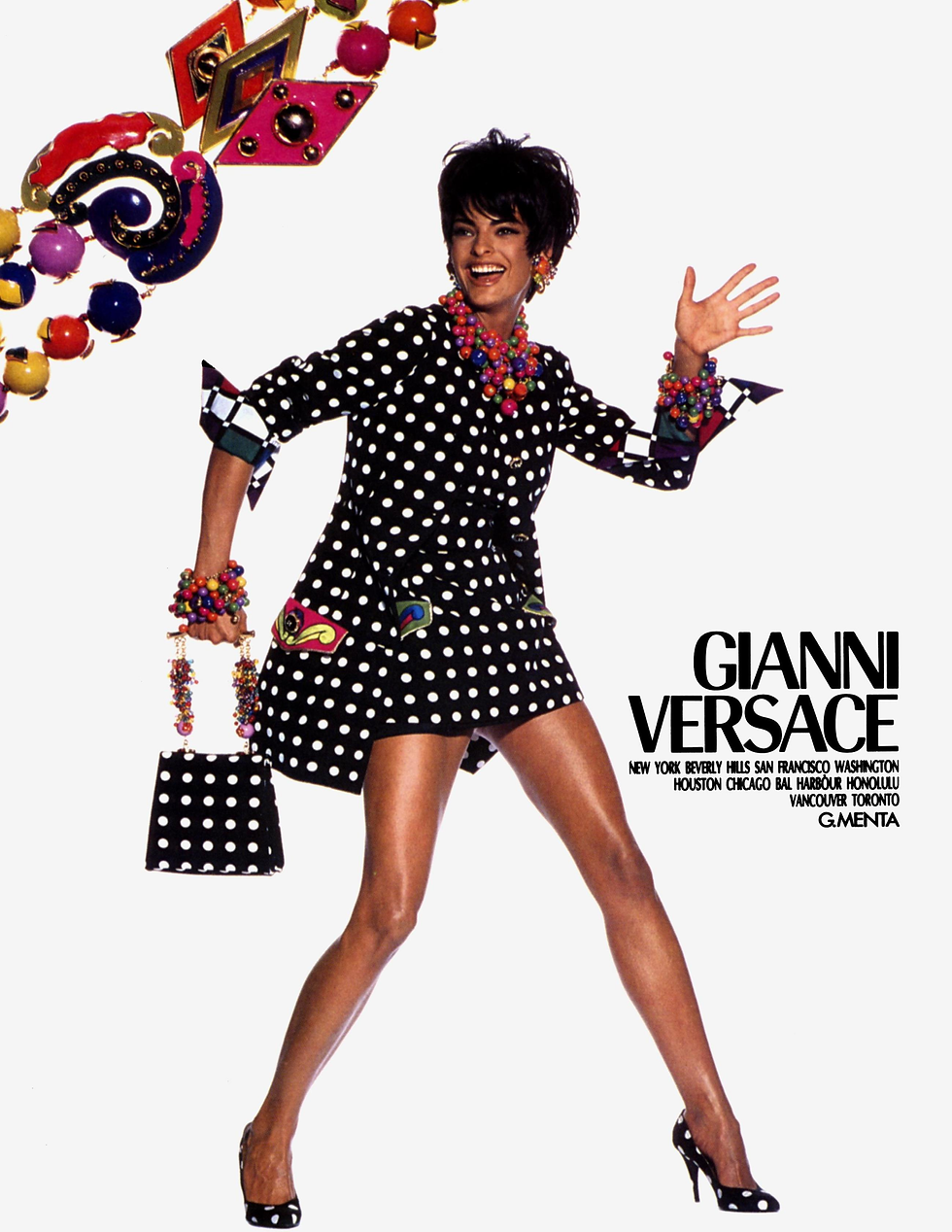 A 1991 Gianni Versace magazine ad showing Linda Evangelista wearing polka dots. Like in the Dua Lipa x Versace collection, the polka dots are combined with multiple bright colours and matching polka dot accessories.