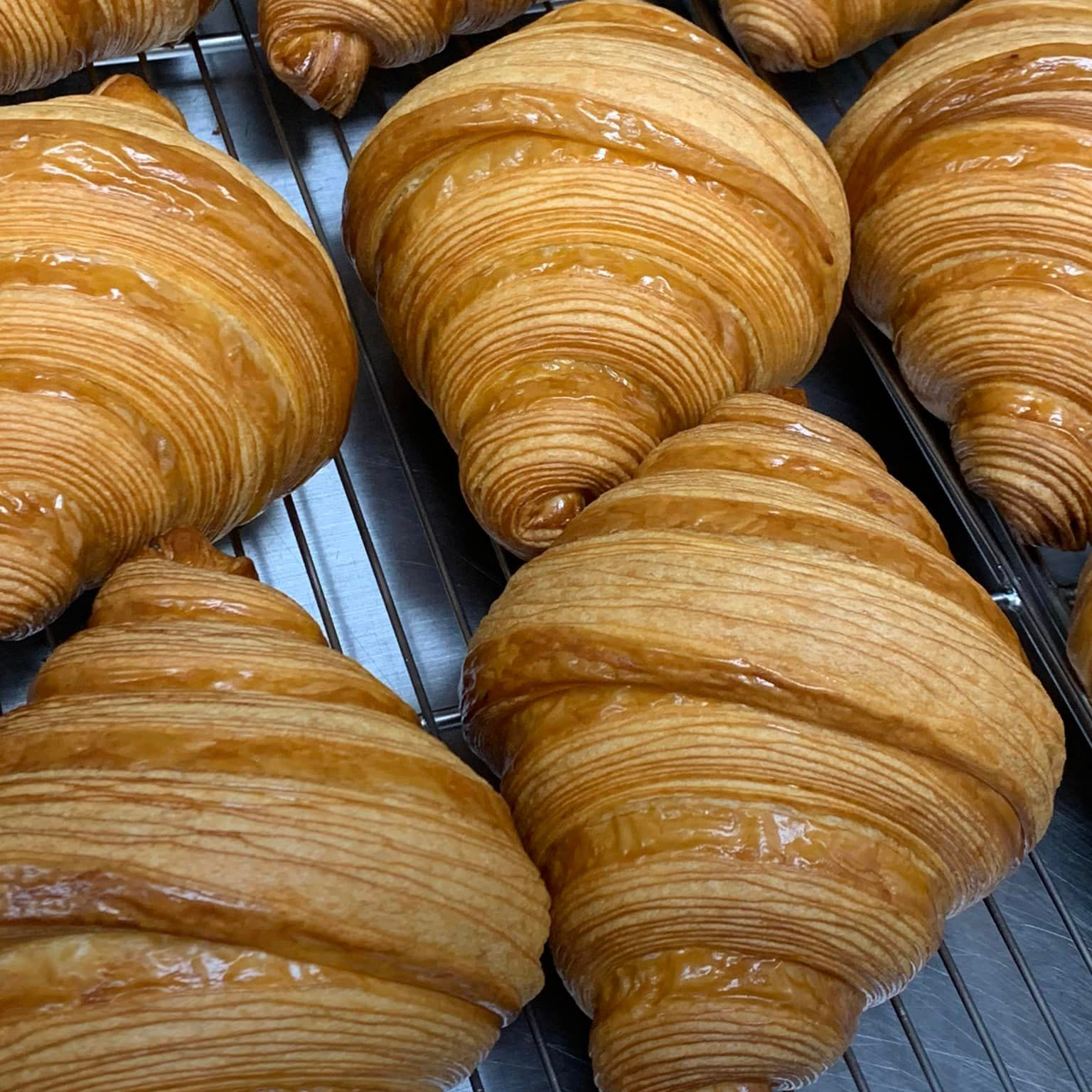 A buttery, flaky pastry crafted to golden perfection, offering a delicate crunch and a soft, airy interior.