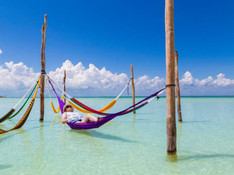 woman-resting-in-a-hammock-at-the-caribbean-island-of-holbox-picture-id1190233703.jpeg
