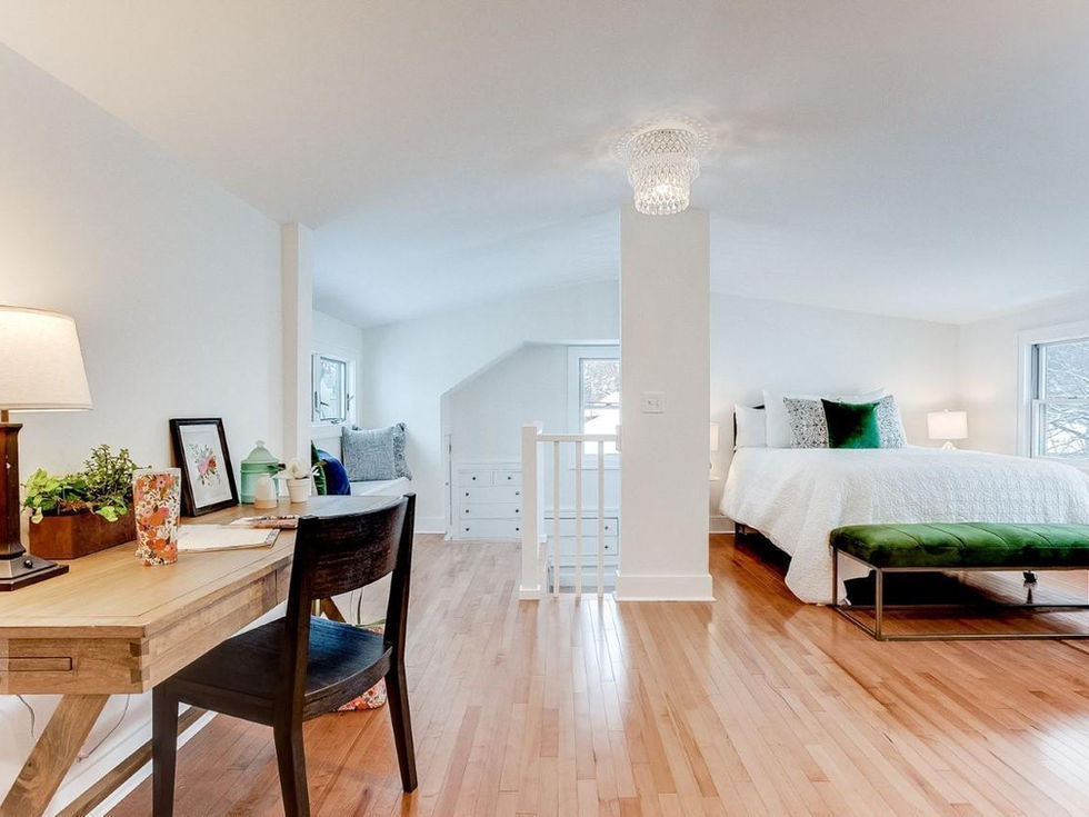 a bedroom with a desk and chair and a bed