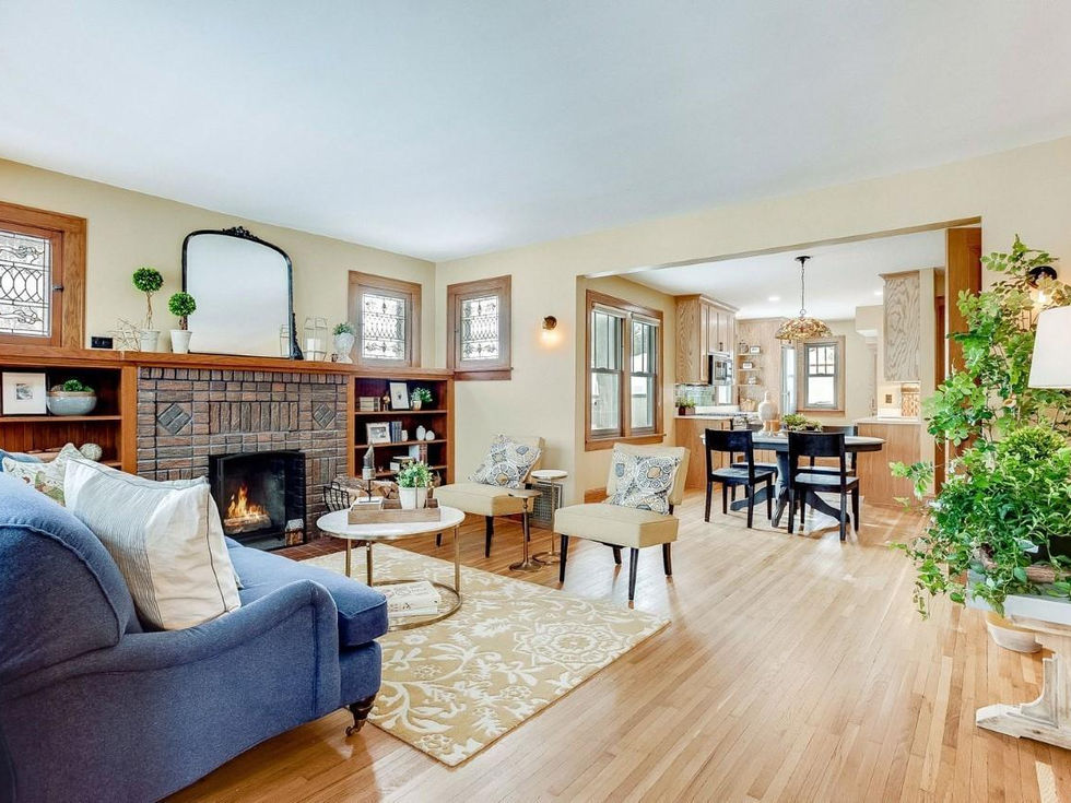 a living room with a blue couch and a fireplace