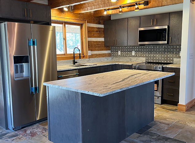Rustic kitchen with custom cabinets and slate tile floor