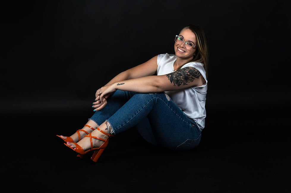 Jorden sits casually on the ground and smiles