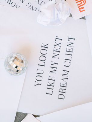 papers scattered on the ground with disco balls on top