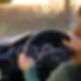 a woman driving a car while holding the steering wheel_edited.jpg