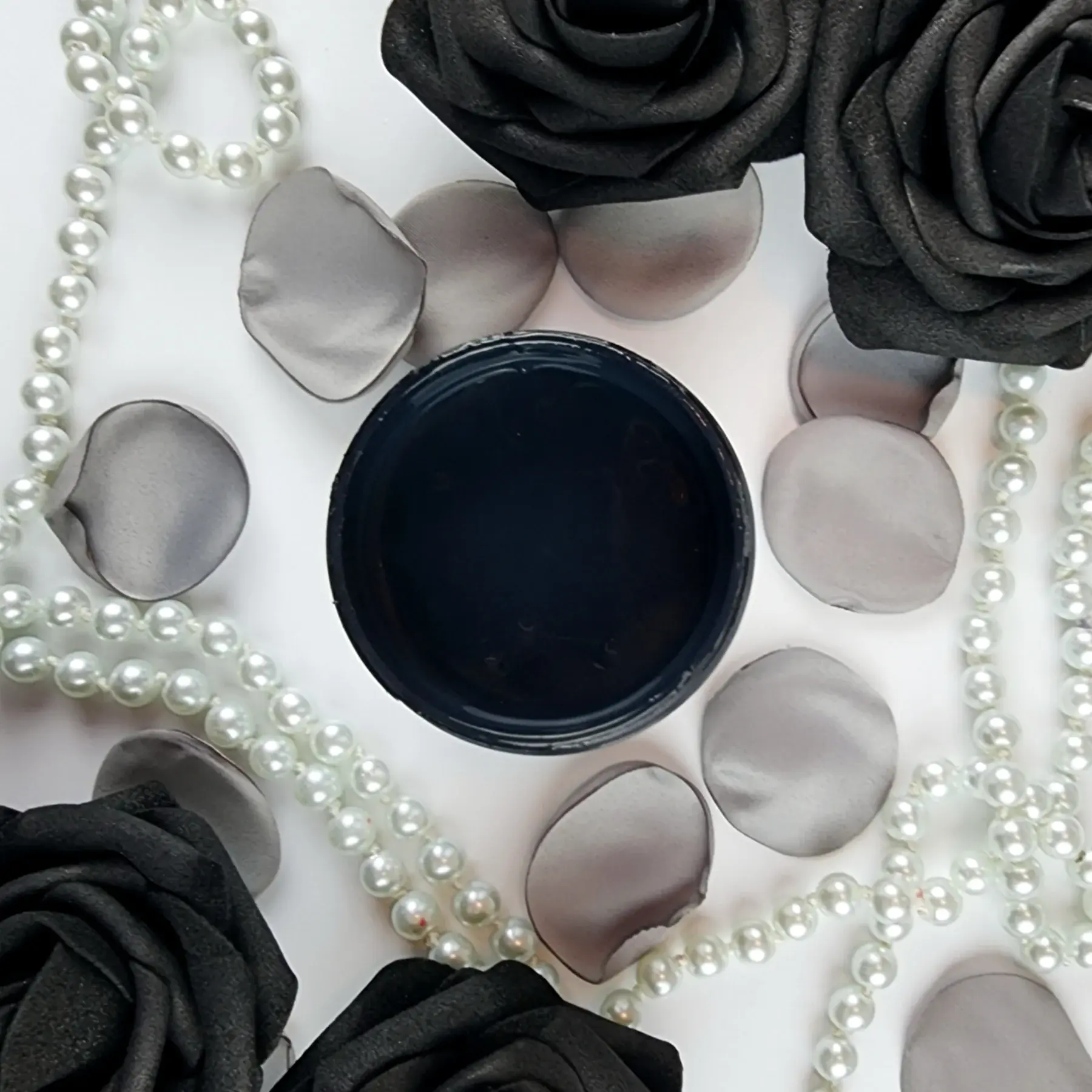 Top view of Baltic Black mineral paint with roses and pearls