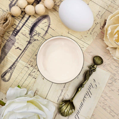 Butter Cream chalk paint in a small bowl with vintage decor.