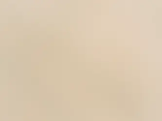 Imitation marble with veining and a chip revealing the substrate.